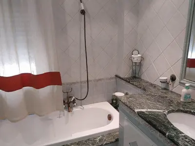 a bathroom with a bath tub and a sink at ROOM VISTAMARE PALERMO in Palermo