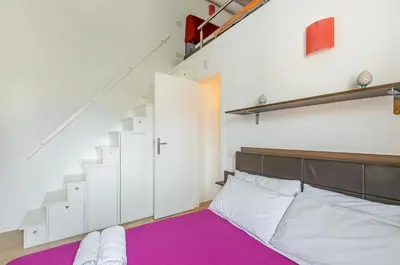a bedroom with a bed with a purple rug at GuestHost - Palermo Modern Apartment with Swimming Pool in Palermo