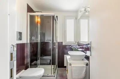 a bathroom with a shower and a toilet and a sink at GuestHost - Palermo Modern Apartment with Swimming Pool in Palermo