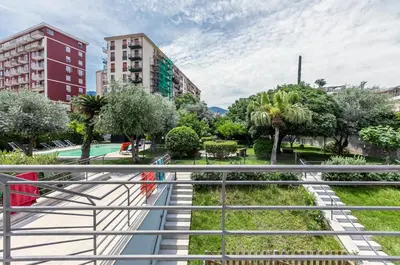a view of a park with trees and buildings at GuestHost - Palermo Modern Apartment with Swimming Pool in Palermo