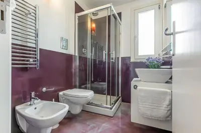 a bathroom with a toilet and a sink and a shower at GuestHost - Palermo Modern Apartment with Swimming Pool in Palermo