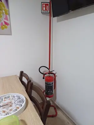 a room with a table with a fire extinguisher on it at Le Cummari in Castellammare del Golfo