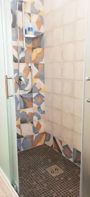 a bathroom with a shower with a glass door at Le Cummari in Castellammare del Golfo