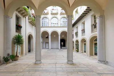 an empty courtyard of a building with columns at Tomasi Apartment Palermo in Palermo