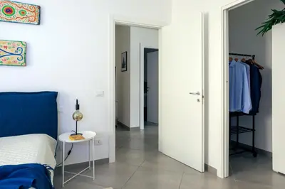 a bedroom with a bed and a table and a closet at Tomasi Apartment Palermo in Palermo