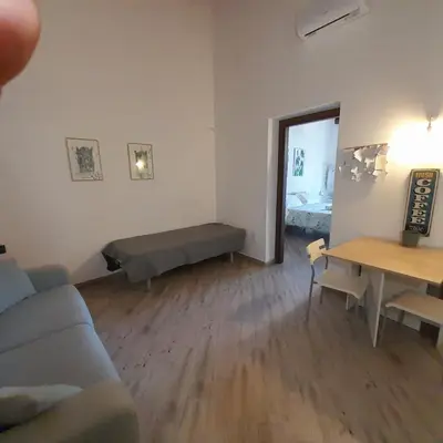 a living room with a couch and a table at Enzo'S Suite in Palermo
