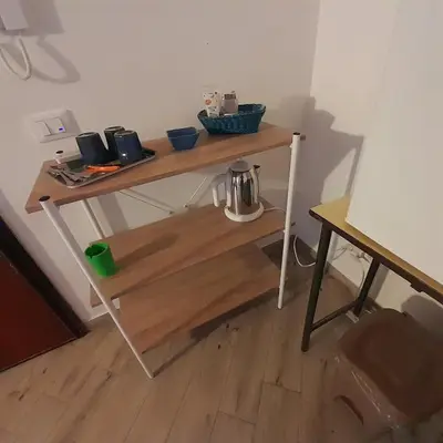 a wooden table with bowls on top of it at Enzo'S Suite in Palermo