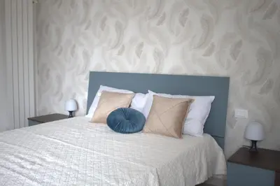 a bedroom with a bed and a large window at Villa Stesicoro Suite in Mondello