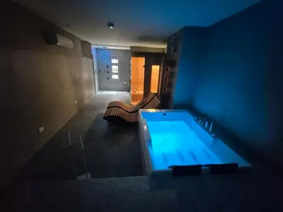 a large bathroom with a tub and a staircase at Villa Stesicoro Suite in Mondello