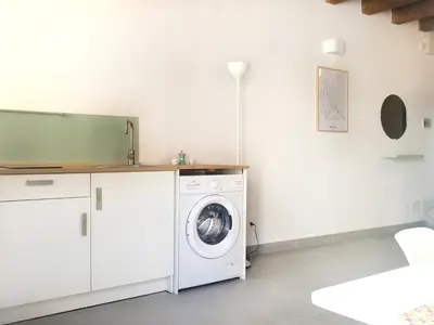 a white laundry room with a washing machine at Vicolo del Capo in Palermo