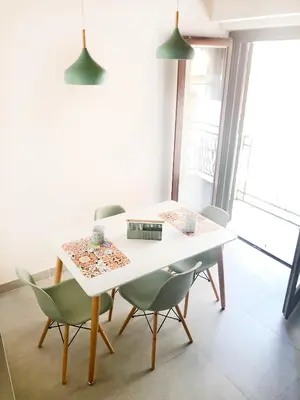 a dining room with a white table and chairs at Vicolo del Capo in Palermo
