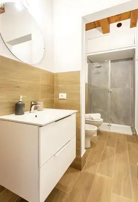 a bathroom with a sink and a toilet at Vicolo del Capo in Palermo
