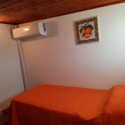 a room with a bed and a picture on the wall at La Rosa dei venti in Calatafimi