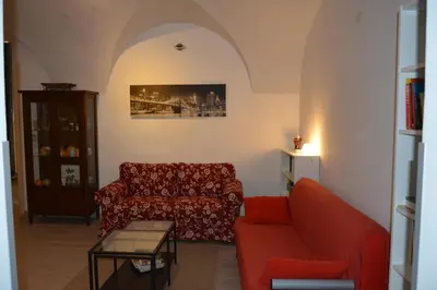 a book shelf filled with books and a cactus at Daysin Apartment in Palermo