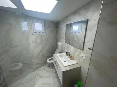 a bathroom with a sink and a toilet and a mirror at Ischia suite in Termini Imerese