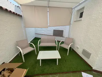 a patio with two chairs and a table and a table and chairs at Ischia suite in Termini Imerese
