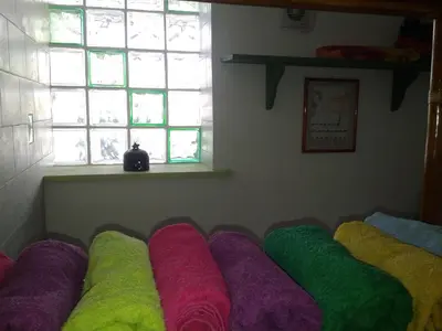 a row of colored pillows in a room with a window at La Casa di Chico in Mondello