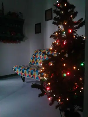 a christmas tree in a living room with a couch at La Casa di Chico in Mondello