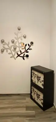 a room with a wall with a bird on a branch at Rosdani Apartment in Palermo