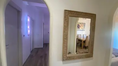 a mirror on a wall in a room with a table at Rosdani Apartment in Palermo