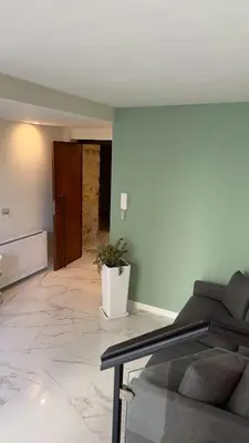 a living room with a couch and a potted plant at Palazzo Maqueda in Palermo