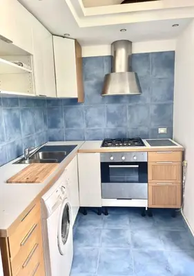 a kitchen with a stove and a washing machine at Stazione Armò in Palermo