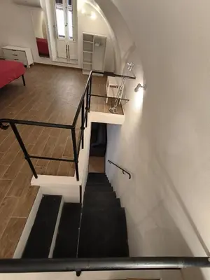a stairway leading up to a room with a stair case at La Volta di Gatto in Palermo