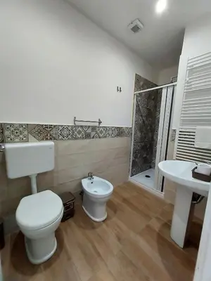 a bathroom with a toilet and a sink and a shower at La Casa del Moro - All' Operà in Palermo