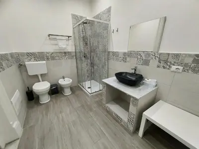 a bathroom with a sink and a toilet and a shower at La Casa del Moro - All' Operà in Palermo