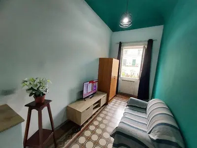 a living room with a bed and a television at La Casa del Moro - All' Operà in Palermo