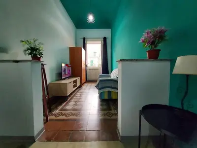 a room with green walls and a room with a bed at La Casa del Moro - All' Operà in Palermo
