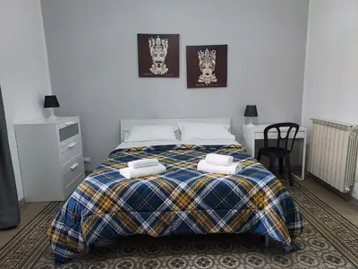 a bedroom with a bed with two towels on it at La Casa del Moro - All' Operà in Palermo