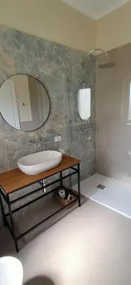 a bathroom with a sink and a mirror at Domus Maqueda - Pressi Teatro Massimo in Palermo