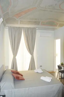 a bedroom with a bed with two towels on it at Domus Maqueda - Pressi Teatro Massimo in Palermo