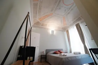 a bedroom with a bed with a coffered ceiling at Domus Maqueda - Pressi Teatro Massimo in Palermo
