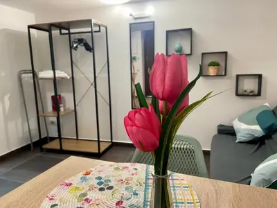 a vase with pink flowers sitting on a table at Casa Labi in Termini Imerese