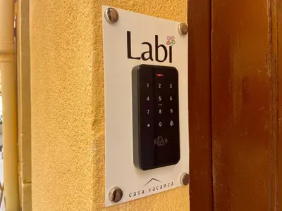 a remote control on the side of a door at Casa Labi in Termini Imerese