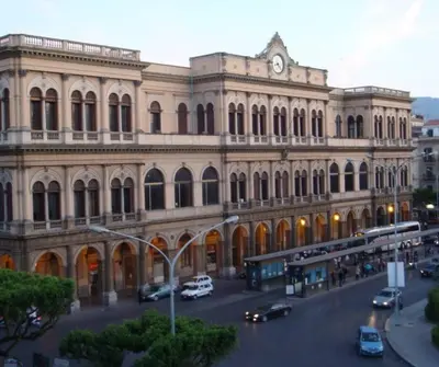 a large building with cars parked in front of it at Casetta Polì- Appartamento con terrazza - Centro Storico in Palermo