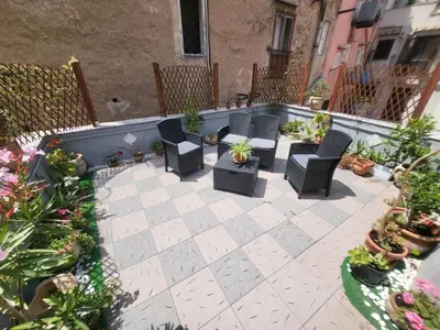 an outdoor patio with chairs and potted plants at Casetta Polì- Appartamento con terrazza - Centro Storico in Palermo