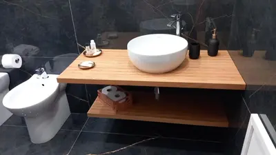 a bathroom with a white sink on a wooden counter at Lu Màri case vacanze in Balestrate