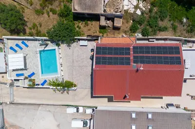 an overhead view of a building with solar panels on it at holiday inn endless summer in Alcamo