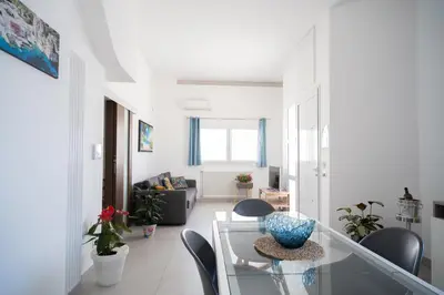 a living room with a glass table and chairs at holiday inn endless summer in Alcamo