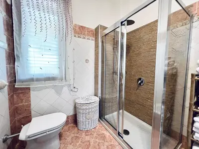 a bathroom with a shower and a toilet at Villa Genova in Carini