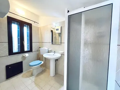 a bathroom with a toilet and a sink at Villa Genova in Carini
