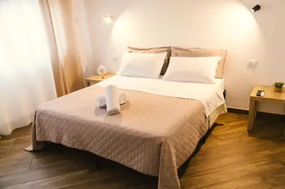 a bedroom with a large bed with towels on it at Galka Rooms in Palermo