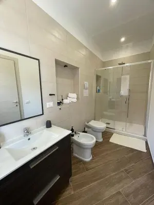 a bathroom with a sink and a toilet and a shower at Galka Rooms in Palermo