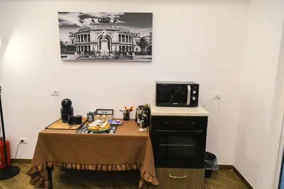 a small kitchen with a table with a microwave at Galka Rooms in Palermo