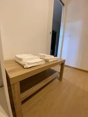 a wooden table with towels on top of it at Artemide 15 New Apartment near Mondello in Palermo