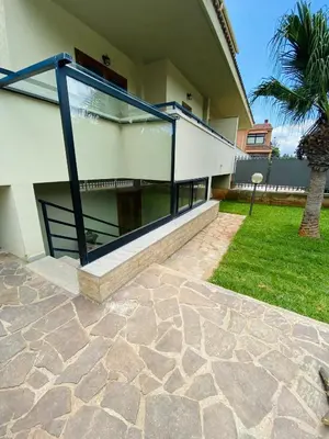 a house with a patio and a grass yard at Artemide 15 New Apartment near Mondello in Palermo