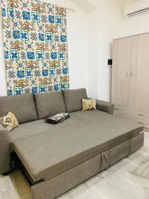 a large couch in a living room with a curtain at A un passo dalla cattedrale in Palermo